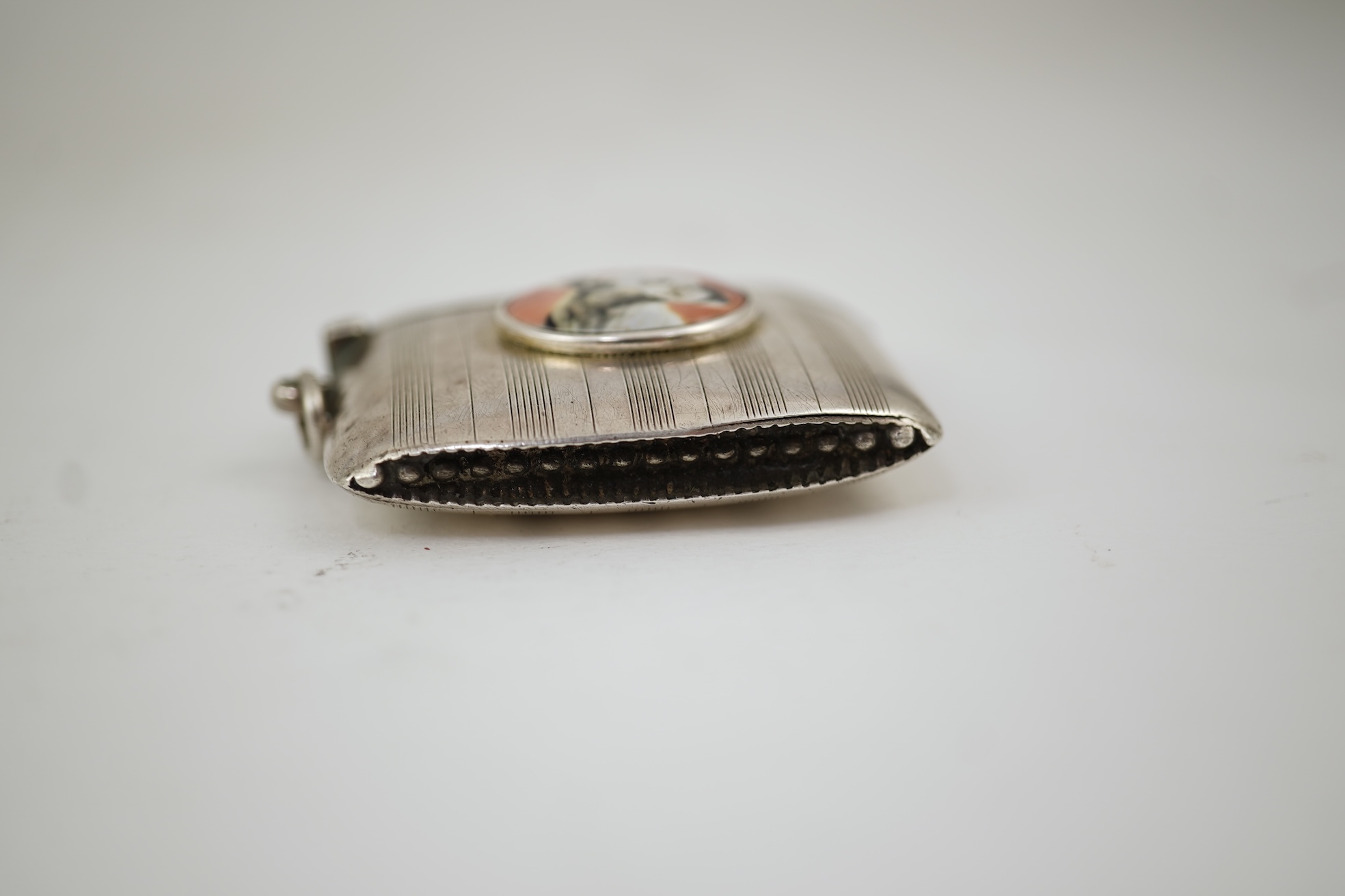 A George V silver and enamel vesta case, by Henry Hyde Aston, the inset circular enamel plaque decorated with a French bulldog